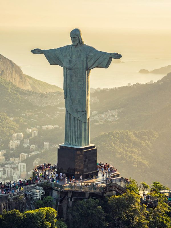 Aerial view of Christ and Sugar Loaf Mountain, Rio De Janeiro, Brazil . People on the top of Corcovado Hill